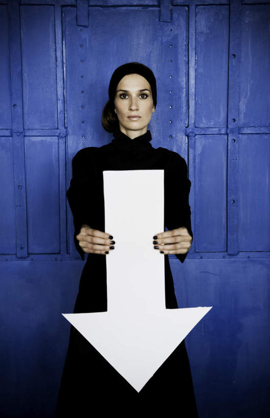 西方人,脸,头,脸颊,手,一个人,站,竖图,室内,特写,白天,正面,欧洲,欧洲人,仅一个年轻女性,仅一个女性,仅一个人,握,服装,墙,拿,拿着,注视,休闲装,方向,箭头,墙壁,墙面,衣服,蓝色,白色,观察,看,靠,靠着,站着,休闲,手部,休闲服,握着,服饰,观看,察看,指向,关注,簇,年轻女性,女人,女性,白种人,头部,脸部,脸蛋,面部,站立,半身,彩图,向下