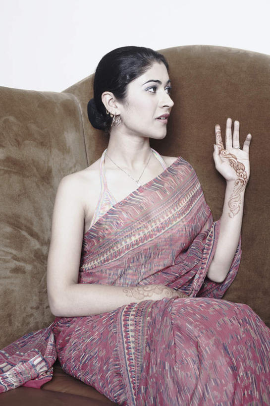 一个人,坐,举,竖图,室内,白天,正面,民族服装,沙发,项链,亚洲,仅一个年轻女性,仅一个女性,仅一个人,戴,挥手,注视,再见,装饰品,耳环,饰品,首饰,观察,看,手势,托,招手,服饰,告别,观看,飘逸,察看,庄重,关注,追求,摆动,布艺沙发,离别,纱丽,雅致,辞行,耳饰,纱丽服,清婉,妍丽,年轻女性,女人,女性,亚洲人,印度人,举起,举手,举着,向上举,向上伸,向上托,坐着,半身,彩图,传统服装,民俗服,奢华