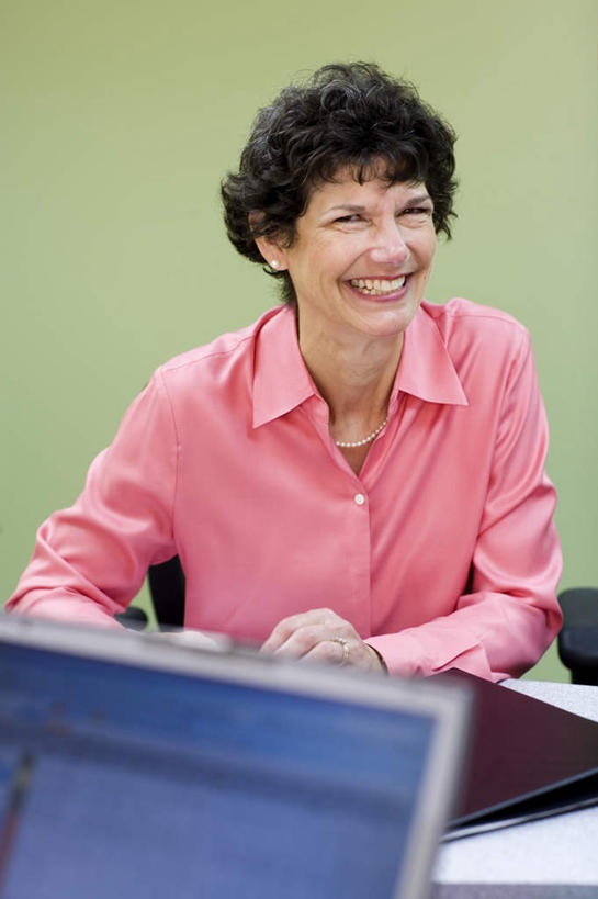 西方人,一个人,商务人士,商务女性,坐,笑,微笑,露齿笑,竖图,室内,白天,正面,电脑,笔记本电脑,桌面,桌子,欧洲,欧洲人,仅一个女性,仅一个人,握,套装,朦胧,模糊,网络,木制,笔,材料,档案,文件,眼镜,纸,墙,办公用品,拿,拿着,注视,通讯设备,墙壁,墙面,文具,木制品,手稿,学习用品,资料,观察,看,仅一个中年女性,握着,观看,文具用品,证明,察看,无线,书写,关注,文档,通信设备,商务装,无线网络,近视眼镜,无线上网,便携式电脑,工薪阶层,蓝宝石,手提电脑,女人,女性,中年女性,白种人,白领,上班族,坐着,半身,彩图