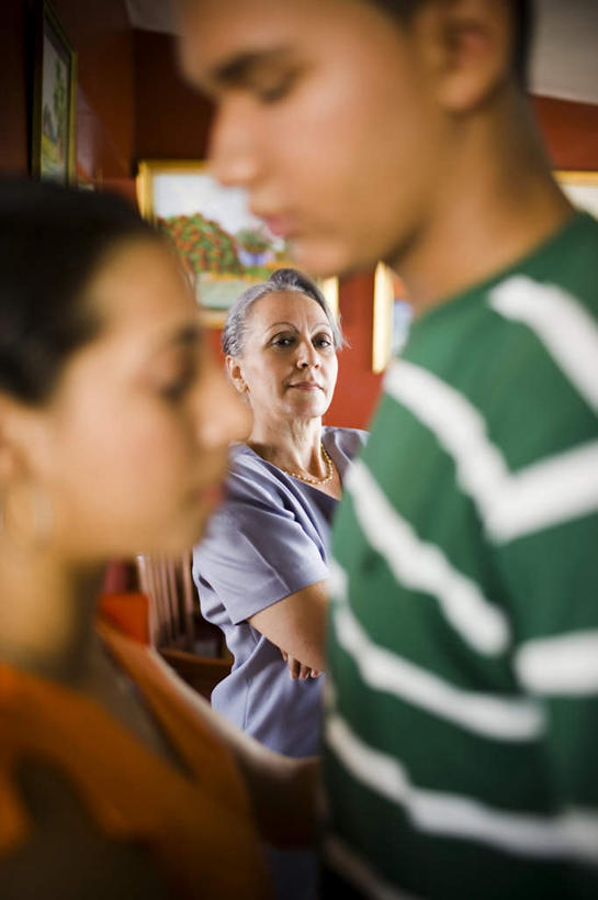 西方人,三个人,站,抱,竖图,室内,白天,侧面,项链,椅子,相框,欧洲,黑人,欧洲人,阴影,条纹,服装,朦胧,模糊,光线,影子,木椅,墙,休闲装,墙壁,墙面,装饰品,衣服,绿色,阳光,耳环,饰品,首饰,站着,休闲,休闲服,服饰,抱着,张望,观望,搂着,耳饰,老年女性,男人,年轻男性,年轻女性,女人,白种人,怀抱,搂,搂抱,相抱,拥抱,站立,半身,彩图