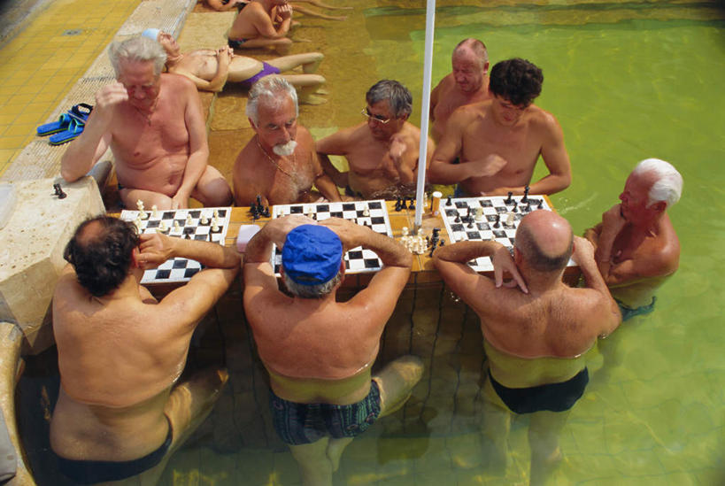 游泳,西方人,胡须,站,坐,横图,俯视,室外,白天,旅游,度假,游戏,快乐,比赛,竞争,桌面,桌子,欧洲,匈牙利,欧洲人,撑,涉水,阴影,短裤,光线,木制,影子,首都,许多人,玩,托腮,注视,娱乐,木制品,象棋,观察,看,托,站着,一群人,享受,休闲,棋盘,国际象棋,放松,益智,观看,活动,察看,布达佩斯,发泄,关注,消遣,智力,托下巴,中欧,宣泄,泅水,渡水,匈牙利共和国,拍浮,男人,男性,年轻男性,白种人,胡子,络腮胡,玩耍,嬉戏,站立,坐着,半身,彩图,高角度拍摄,泳衣