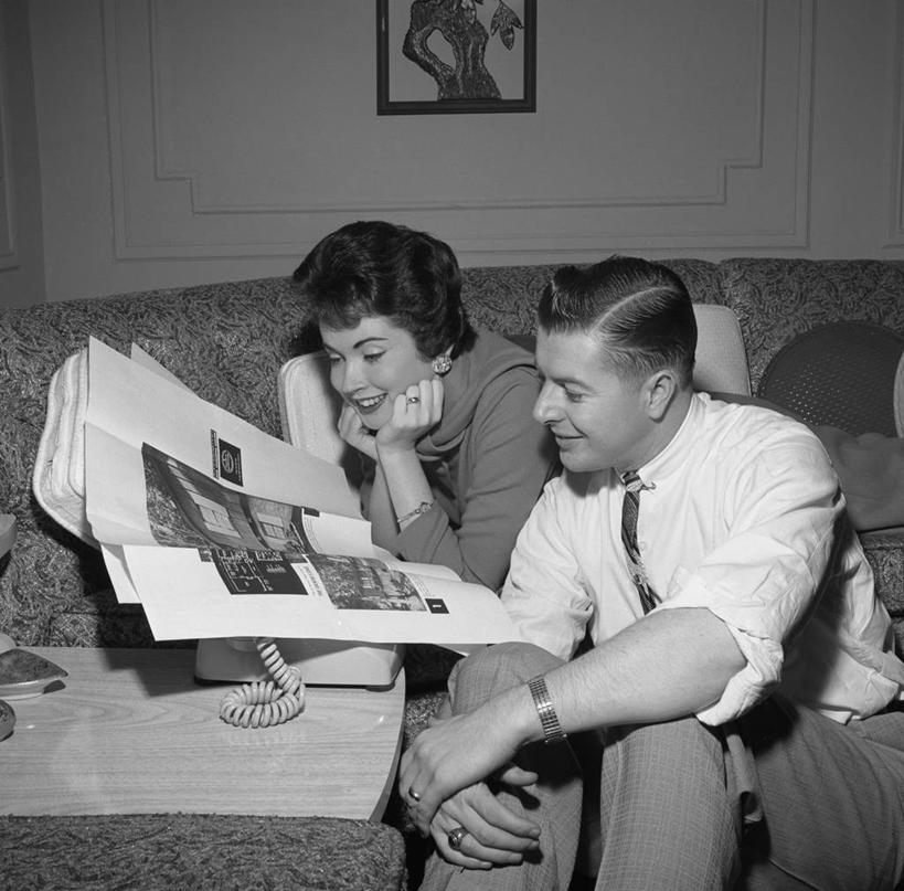 成年人,中年人,两个人,坐,横图,黑白,室内,白天,沙发,报纸,纽约,美国,撑,古典,托腮,休闲装,趴着,托,放松,读书,摄影,起居室,撑着,托下巴,异性恋,中年男性,中年女性,座机,休闲活动