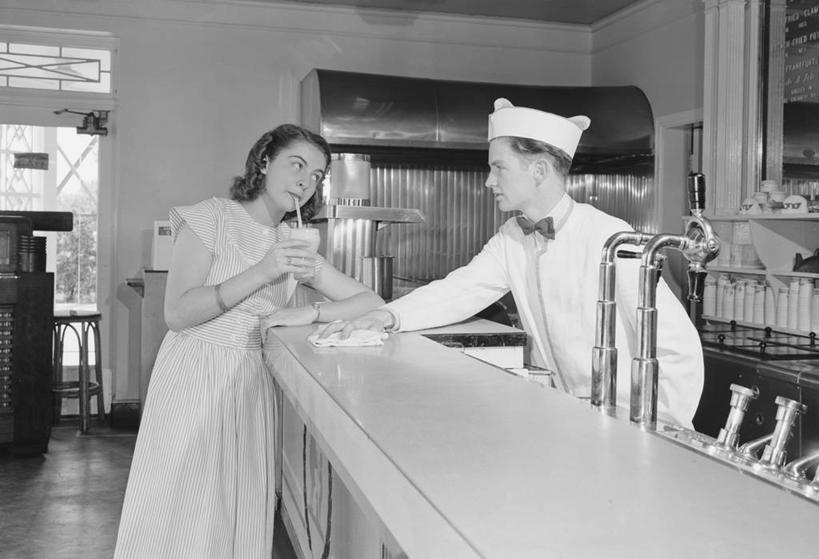 牛奶,成年人,两个人,酒吧,站,横图,黑白,室内,白天,侧面,制服,吧台,帽子,美国,工作,古典,拿着,抹布,饮食,调酒师,饮料,吸管,冷饮,调情,摄影,享乐,奶昔,年轻男性,年轻女性,年轻人,侍者,玻璃杯,休闲活动,清洗,咖啡馆,美人,混合饮料