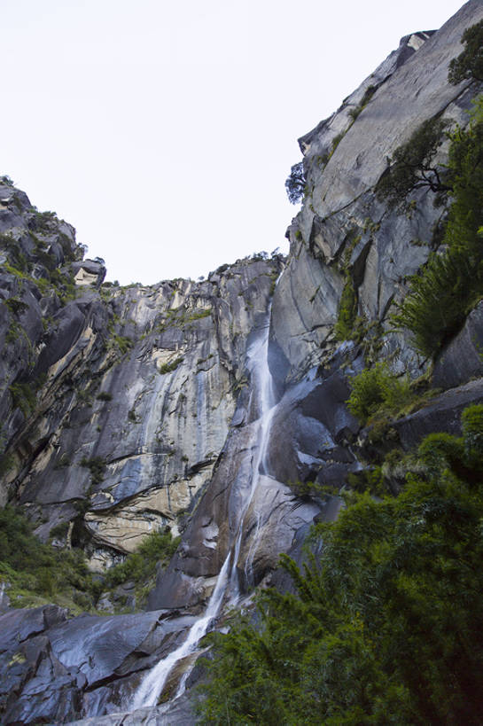 无人,竖图,室外,白天,仰视,旅游,度假,石头,美景,瀑布,山,水,植物,中国,亚洲,地形,景观,流水,山顶,悬崖,苔藓,山谷,娱乐,林芝,西藏,草,树,绿色,风景,天空,自然,享受,休闲,陡峭,景色,放松,摄影,流动,灌木,宁静,岩层,自然风光,东亚,西藏自治区,青藏高原,地质学,自然地理,岩石,彩图,低角度拍摄,旅行,广角,卡定沟,卡定天佛瀑布,bj175